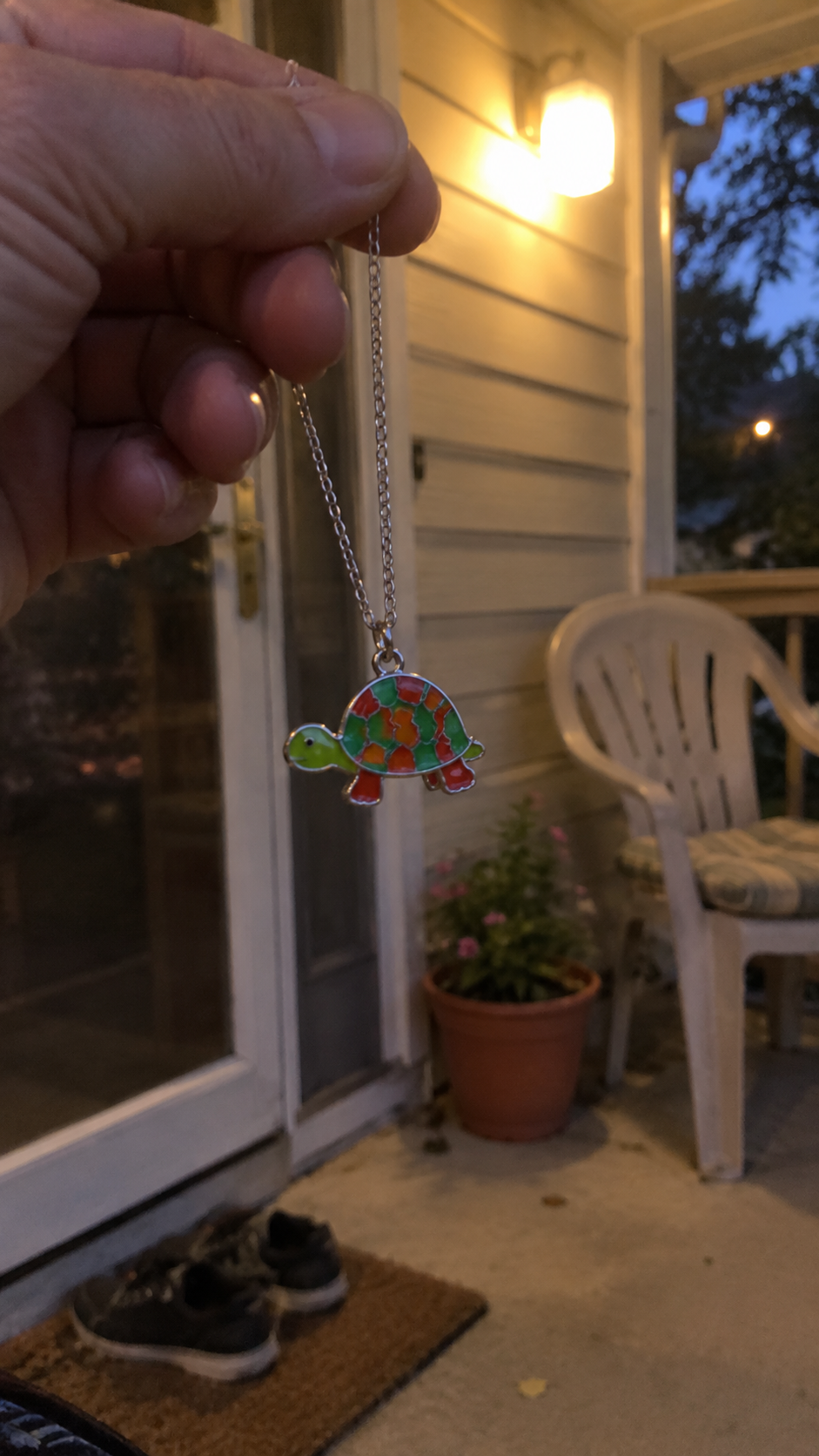 Colorful turtle pendant hanging from its chain